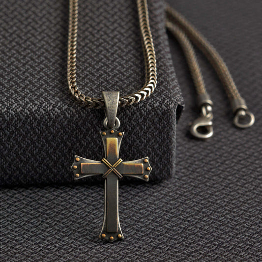 This chain necklace has a very edgy look.  The 22" chain is a small rope style with a 3 dimensional gold/silver cross about 2" long by 1-1/4" wide.  Made of Silver Plated Zinc (Nickle, Lead and Cadmium free). Designed in USA. Made in Taiwan.