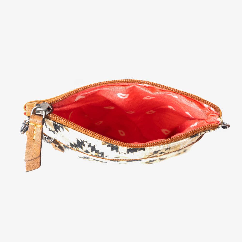 Small pouch with a red interior and patterned exterior on a white background