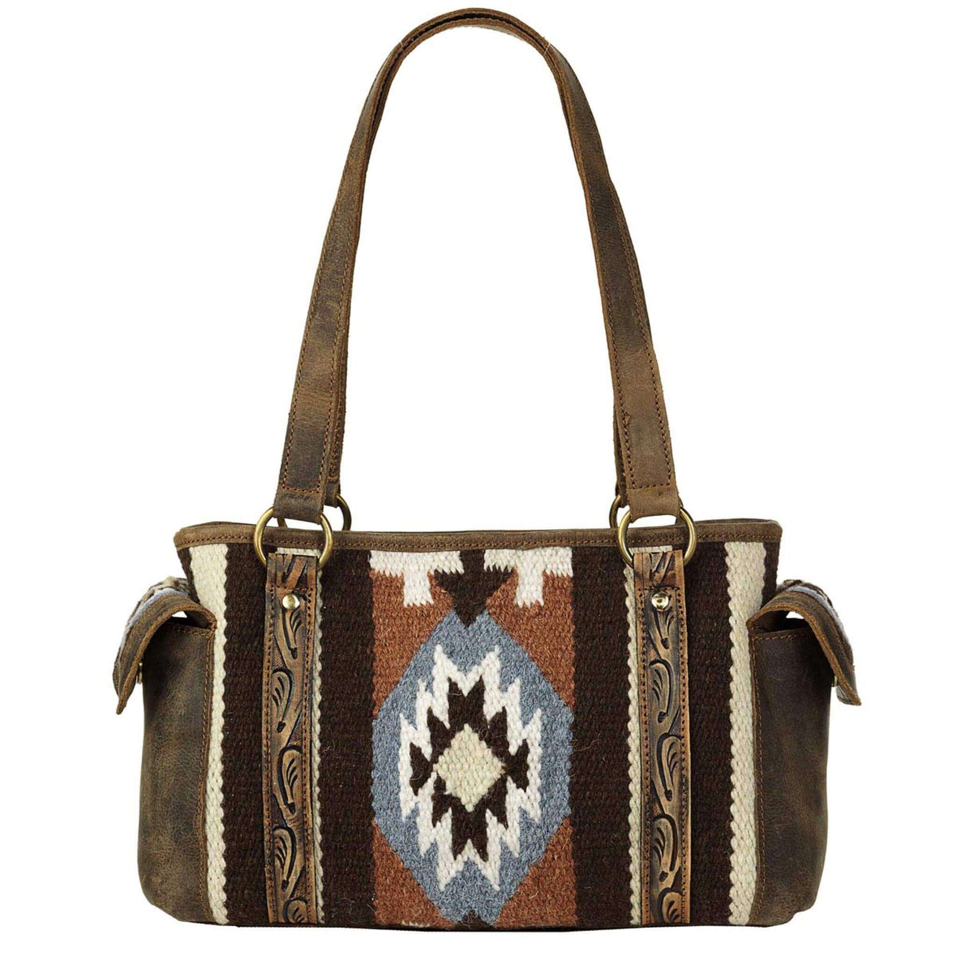 This Ariat wool blanket satchel is brown with orange, blue and ivory in a southwestern pattern. Genuine leather on back, on handles and edge tooling. Zip closure on top of back to keep your items safe. Pockets on Outside Edges, 4 Pockets on Inside. Measures: 14 x 8-1/2 x 6. Imported