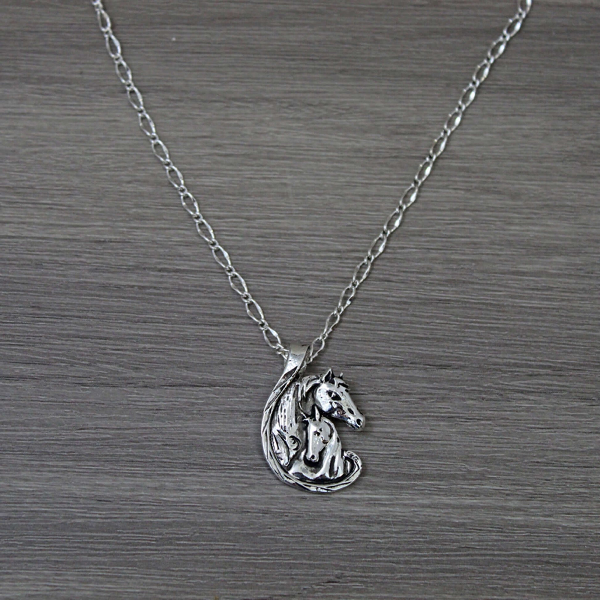 A special necklace perfect for a mother, daughter or lady in your life to show them how much they mean to you. Two horses embrace love and affection on an 18" chain. Pendant measures 1-1/4" tall by 1" wide.