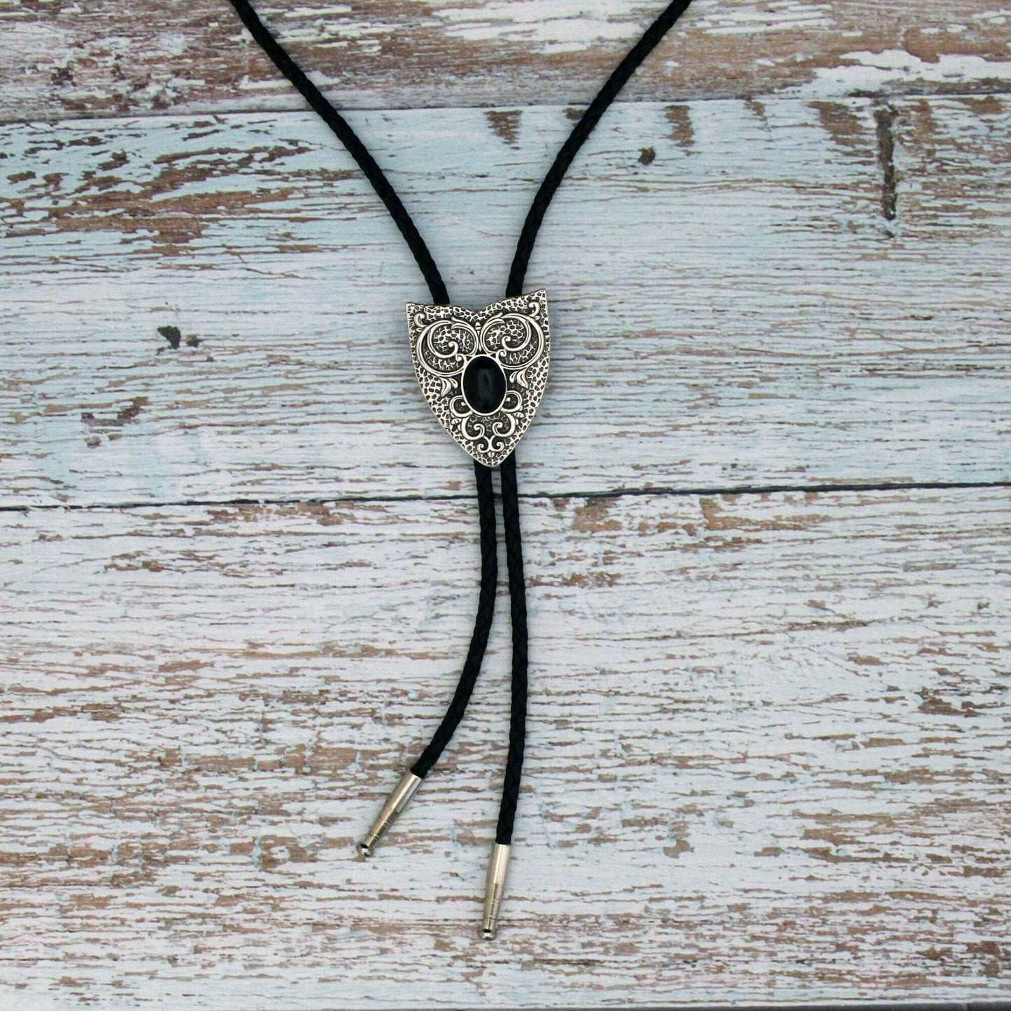 Decorative bolo tie on a wooden surface