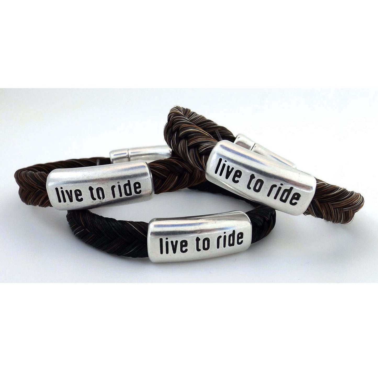Living to Ride is what we are all about. It's how we spend our leisure time. It's what we live for! What's your ride? These handsome horsehair bracelets are accented with “live to ride” on metal slide. Each is finished with a magnetic clasp for easy attachment and is available in three sizes. A statement piece for both men & women.