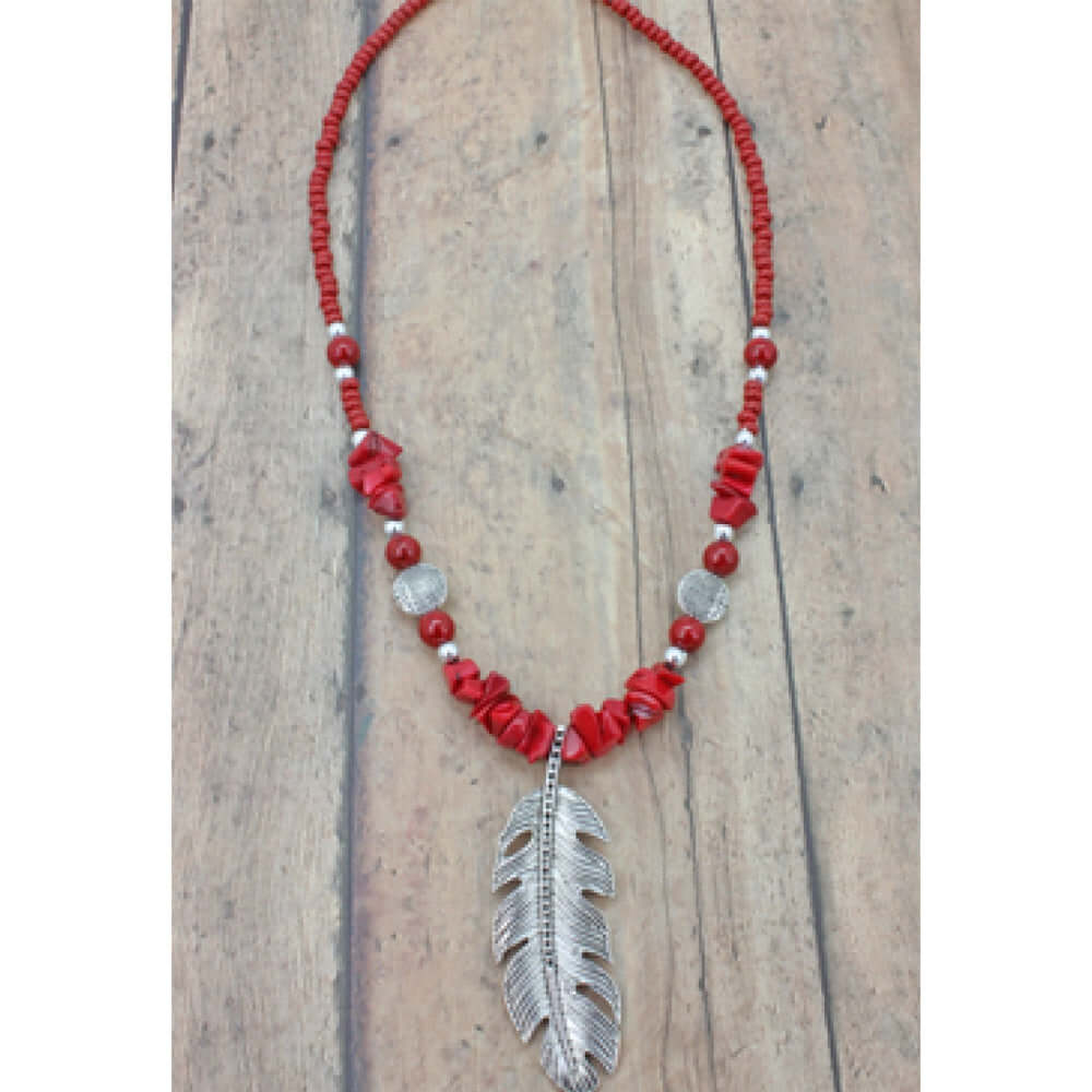 Bamboo coral chips carefully stranded make this gorgeous necklace standout and a silver tone feather pendant hangs down giving it that spiritual western feel. Handcrafted in the Black Hills, SD. Necklace measures 16-20″. Feather pendant is approximately 2" long.