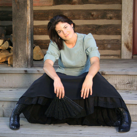 Our popular Bustle Skirt is a perfect match to any western blouse. Offered in flowing microfiber fabric, this skirt swishes and flows with every move. Versatile and fashionable, every wardrobe should have one. Elastic in the back waistband makes for a comfortable and adjustable fit. Back zipper, side pockets. Fine Microfiber Polyester. Made in USA