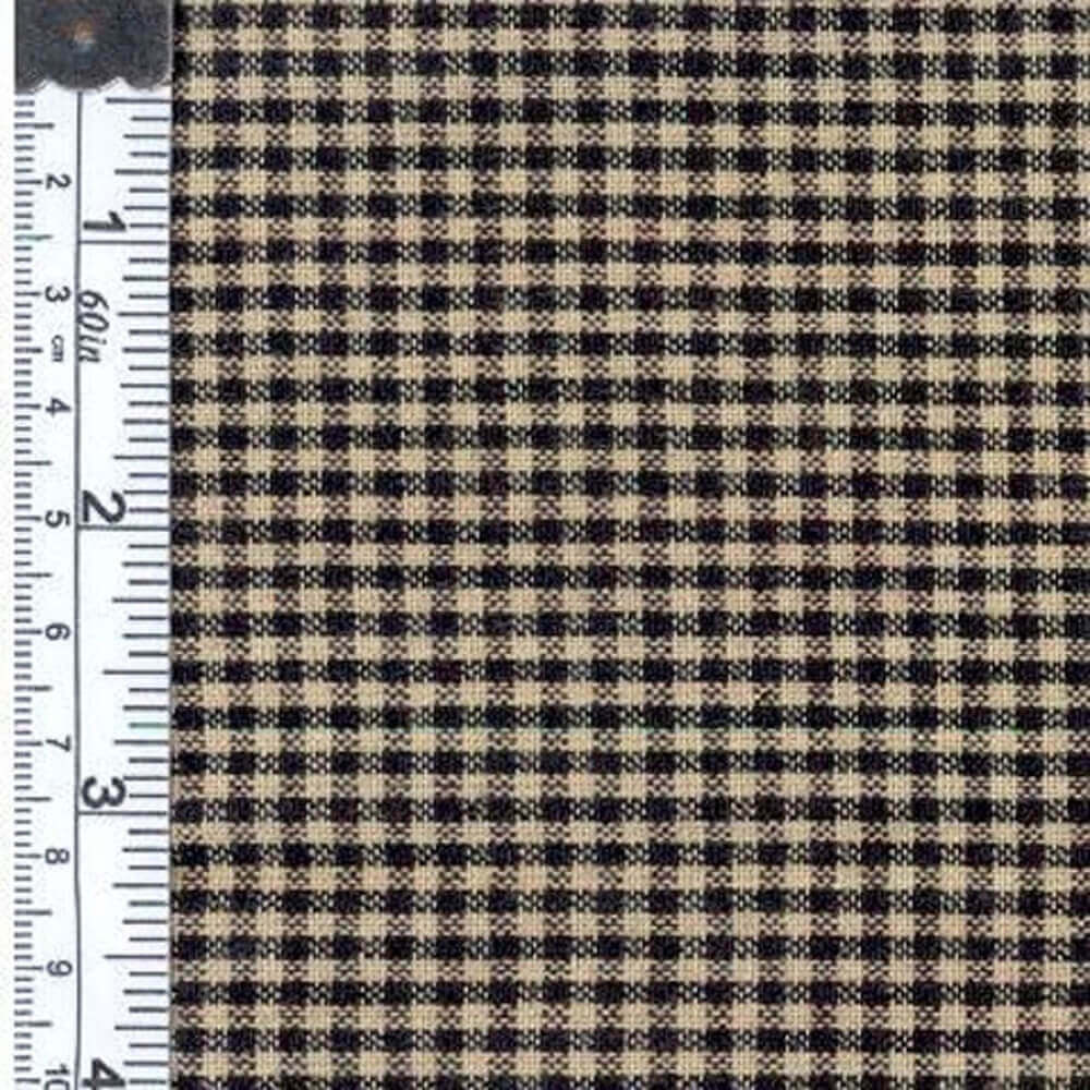 Close-up of checkered gingham fabric in black and beige, featuring a ruler for size reference.