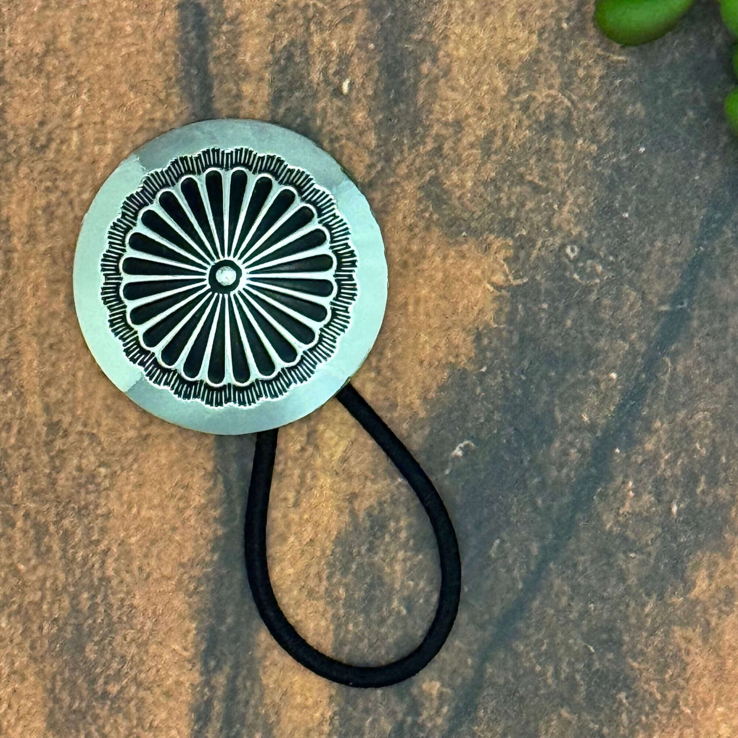 Vintage German silver-plated concho ponytail holder attached to an elastic hair band, stylish accessory.