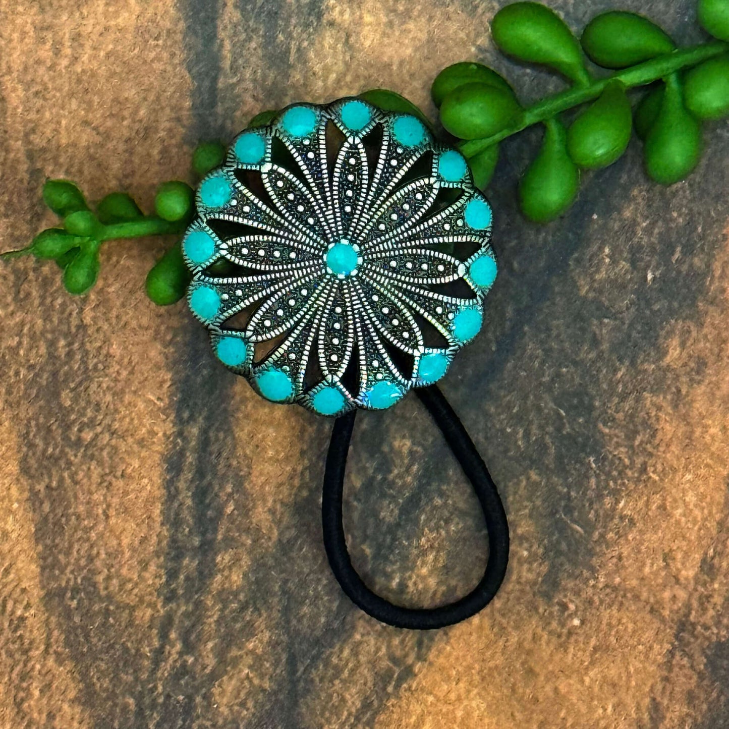 Vintage German silver-plated concho ponytail holder with turquoise accents on an elastic band.