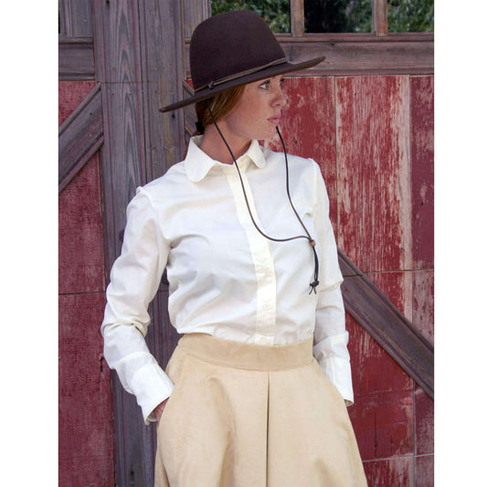 Women's Corral Western Blouse featuring a round collar and button-down front, styled with a beige skirt and hat.