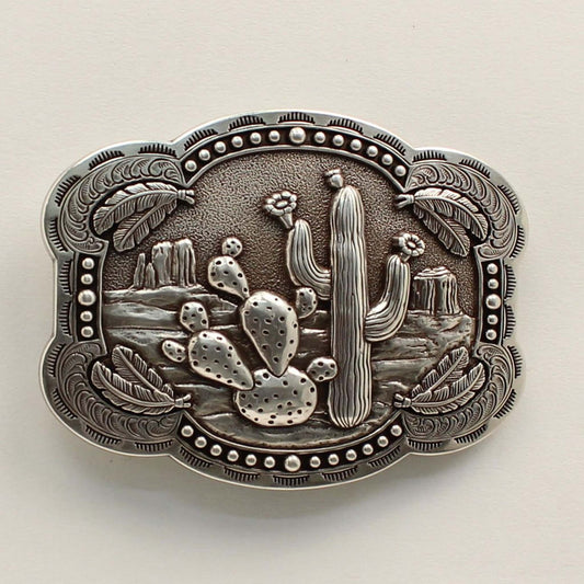 <span data-mce-fragment="1">This rectangle western buckle features a smooth edge with an antique desert scenery in the background with stamped cactus. There is western scrolling and feathers on the corners and small dots on the edges. </span><span data-mce-fragment="1" lang="EN-US">Measures: 3-3/4 x 3-1/4 Imported</span>