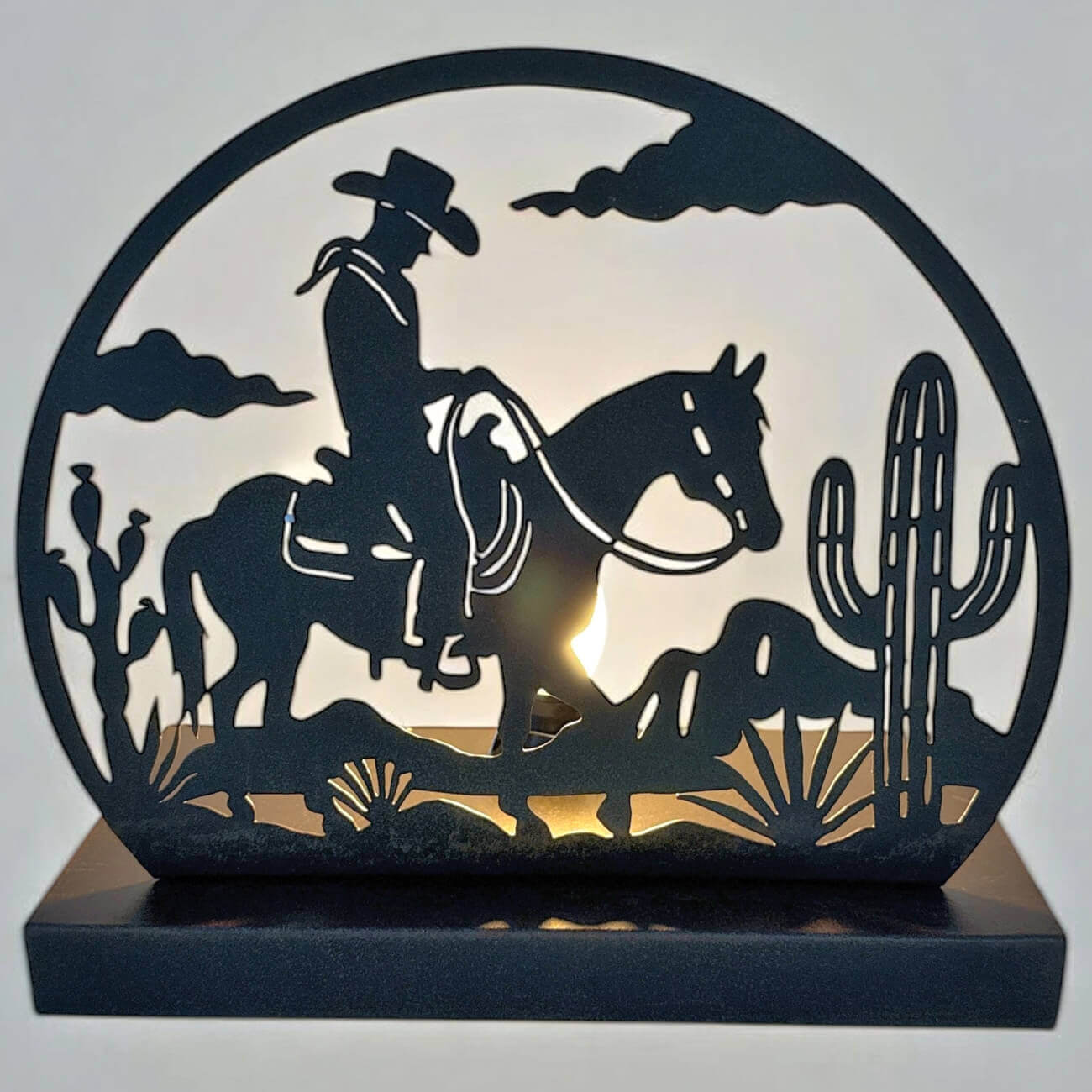 Decorative lamp with a cowboy and horse silhouette, cacti, and sunset design.