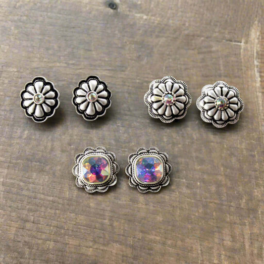 Each earring showcases a stunning aurora borealis crystal at its center, capturing light and adding a touch of sparkle to any outfit. Designed as post-style earrings, measuring 3/4", these earrings are the ideal size. Embrace your inner cowgirl with this stylish and versatile set that effortlessly combines elegance and western flair. Made in China.