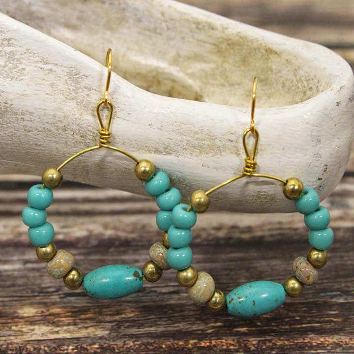 Crafted with a delicate gold wire hoop and adorned with exquisite Magnesium Turquoise, these earrings measure approximately 1″ in diameter from the base of the hypoallergenic ear wires, ensuring comfort for all-day wear. Handcrafted in the USA.