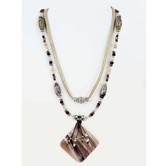 The pendant is Porcelain Jasper Stone measuring 2ā³ wide and 2ā³ long. Two strands with silver beads finish this look and measures 22ā³ including a 4ā³ extender and lobster claw clasp. Each piece is unique and may vary slightly.