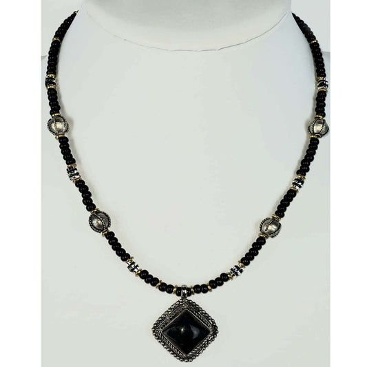 Black horn pendant 1ā³ square framed in antique silvertone with black and silver beads on a single strand. Measures 20ā³ including a 4ā³ extender and lobster claw clasp. Each piece is unique and may vary slightly. Made in USA.