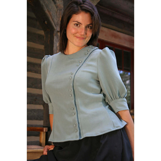 Ella Country Blouse in soft blue featuring fitted princess seams and elegant puff sleeves, perfect for a feminine look.