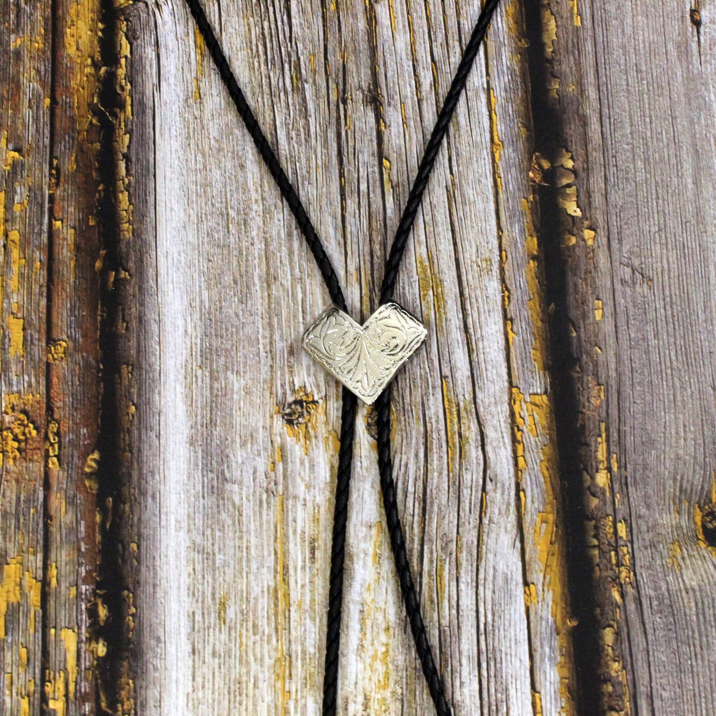 Bolo Tie with a V-shaped pendant on a wooden surface