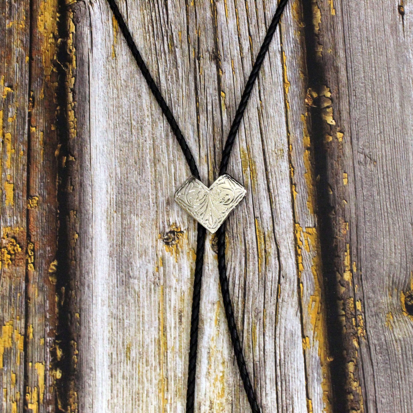 Bolo Tie with a V-shaped pendant on a wooden surface