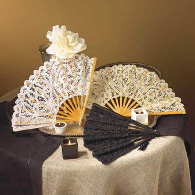 Battenburg Lace Ladies Old West Fan Accessory displayed with lace fans in ecru and black colors on a table.