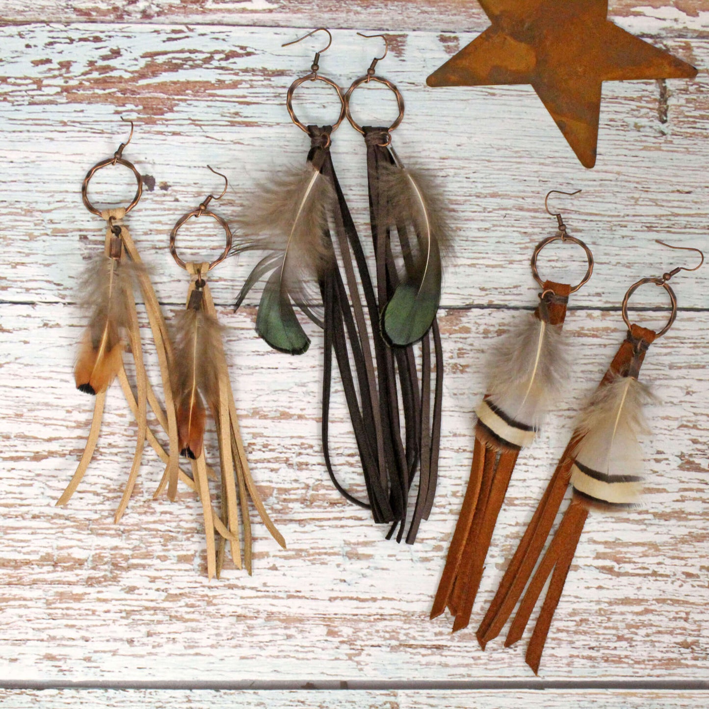 Feather and Leather Tassel Western Earrings featuring natural feathers and leather tassels on copper hoops.