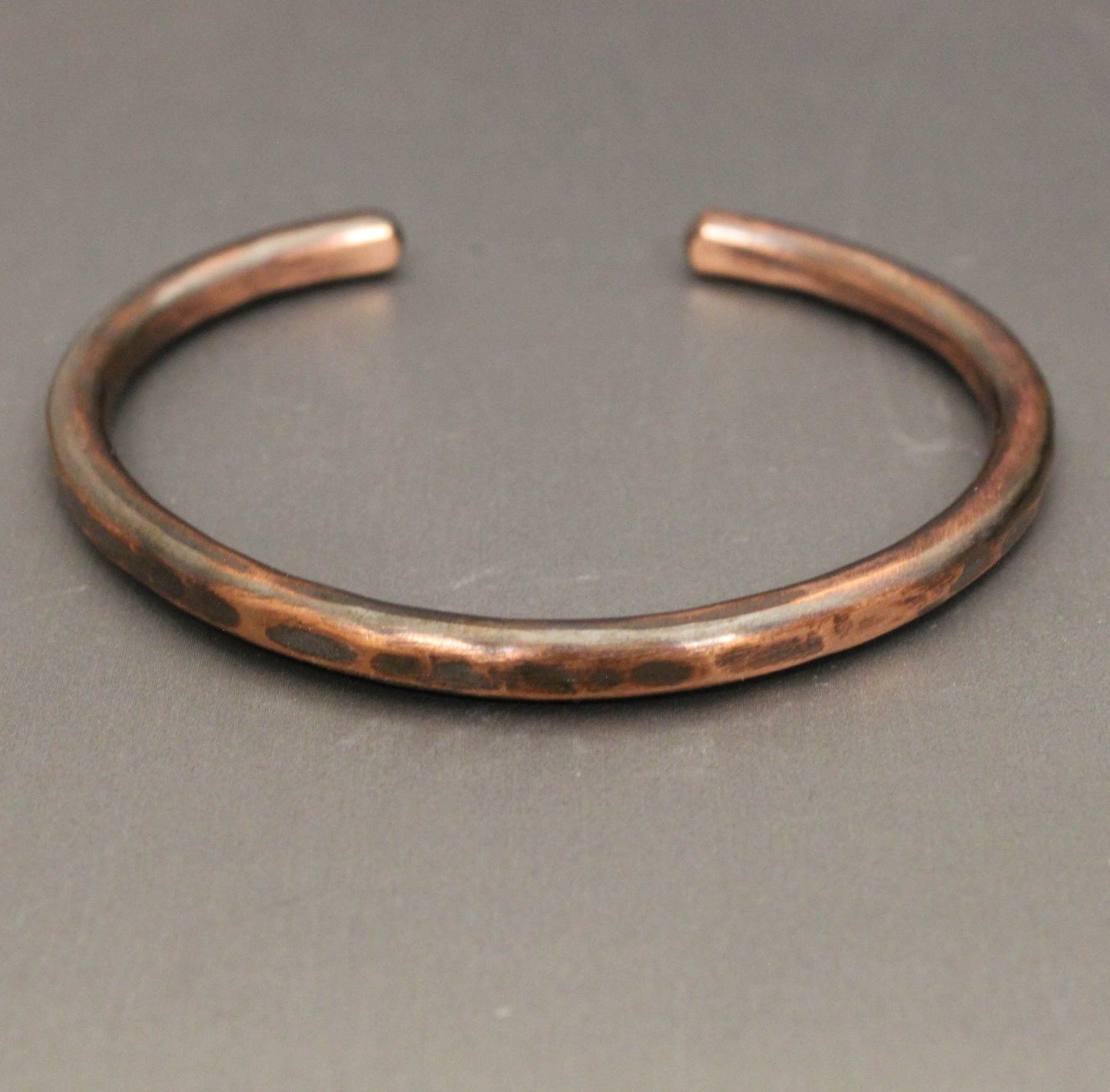 Copper bracelet on a gray background