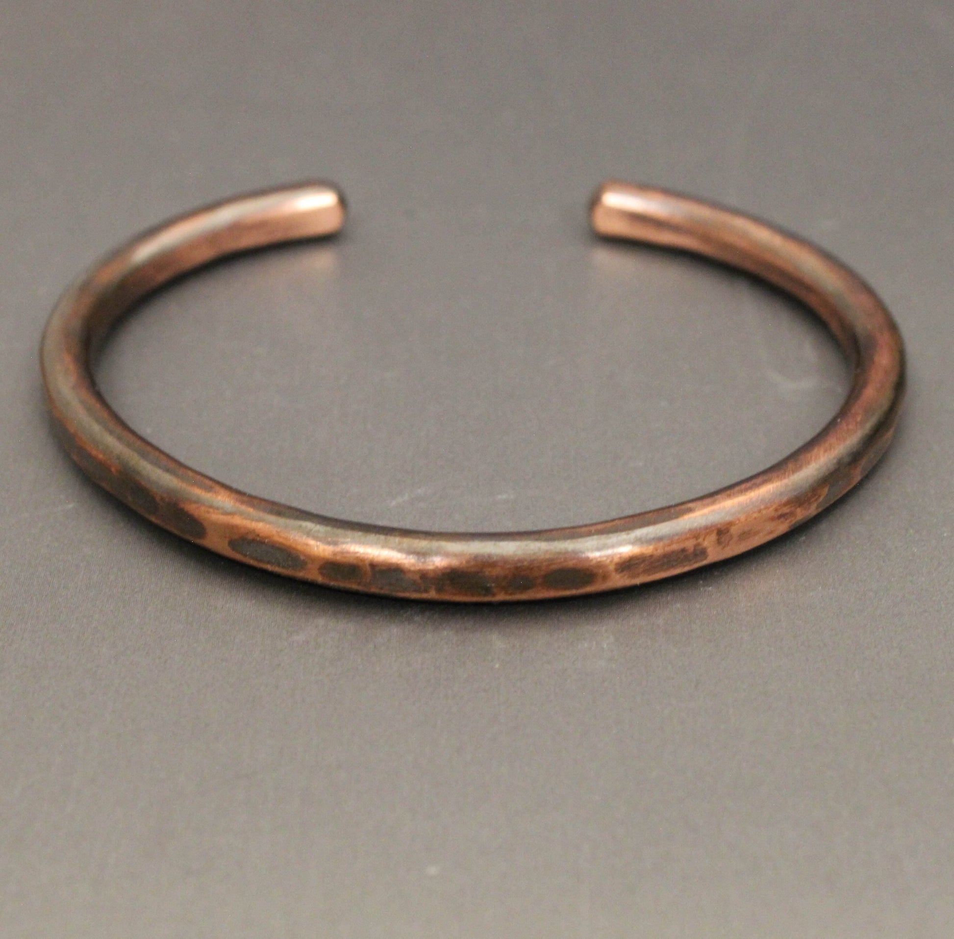 Copper bracelet on a gray background