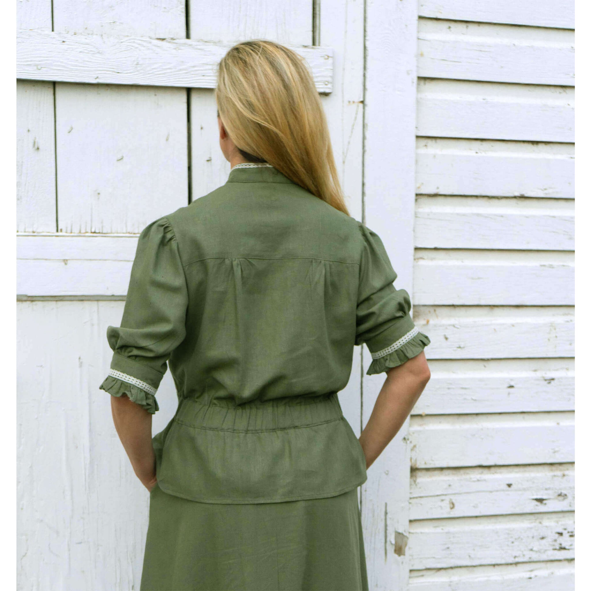 Back view of Western Women's Homestead Blouse in olive green with ruffled sleeves and elastic waist.