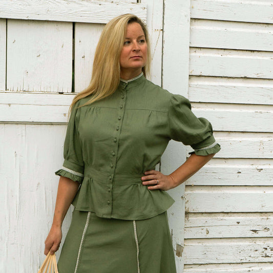 Western Women's Homestead Blouse in green, featuring ruffles and a flattering silhouette, styled with matching Frontier Skirt.