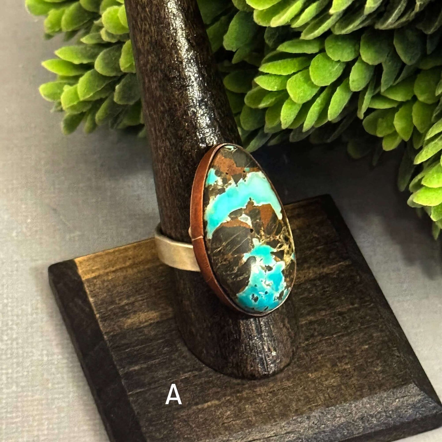 Handmade J Marie Genuine Turquoise Ring on display, featuring a vibrant turquoise stone and adjustable band.