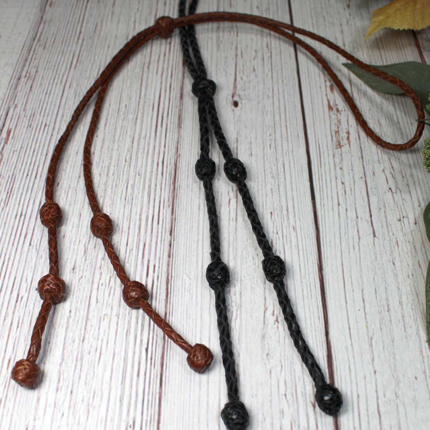 We love the look of these leather bolo ties. A simple take on the traditional bolo tie. Still dressy enough for that special even but casual in style. For men or women! Choose from Brown or Black. Measures 36" end to end.