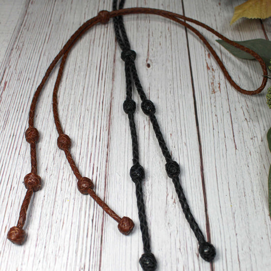 We love the look of these leather bolo ties. A simple take on the traditional bolo tie. Still dressy enough for that special even but casual in style. For men or women! Choose from Brown or Black. Measures 36" end to end.