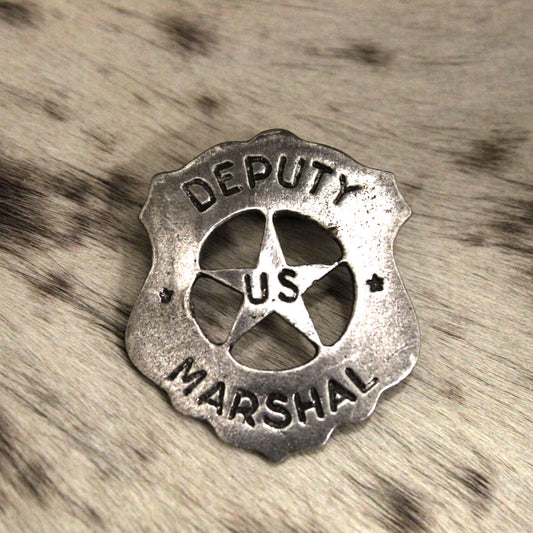 This type of badge was worn by the infamous Earp brothers, Wyatt and Virgil. This is also the type of badge worn by James Arness as Matt Dillon in the television series Gunsmoke.  Made just like those from the past. Cast pewter with awesome detail. Antique silver finish. Measures 2 5/8" tall by  2 1/8" wide. Comes displayed in an old west card. Proudly made in the USA.