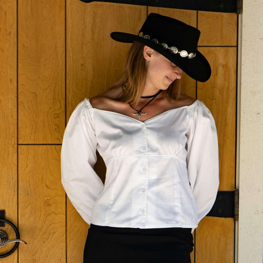 Woman wearing Mesa Cowgirl Western Blouse with sweetheart neckline, paired with a black cowboy hat.