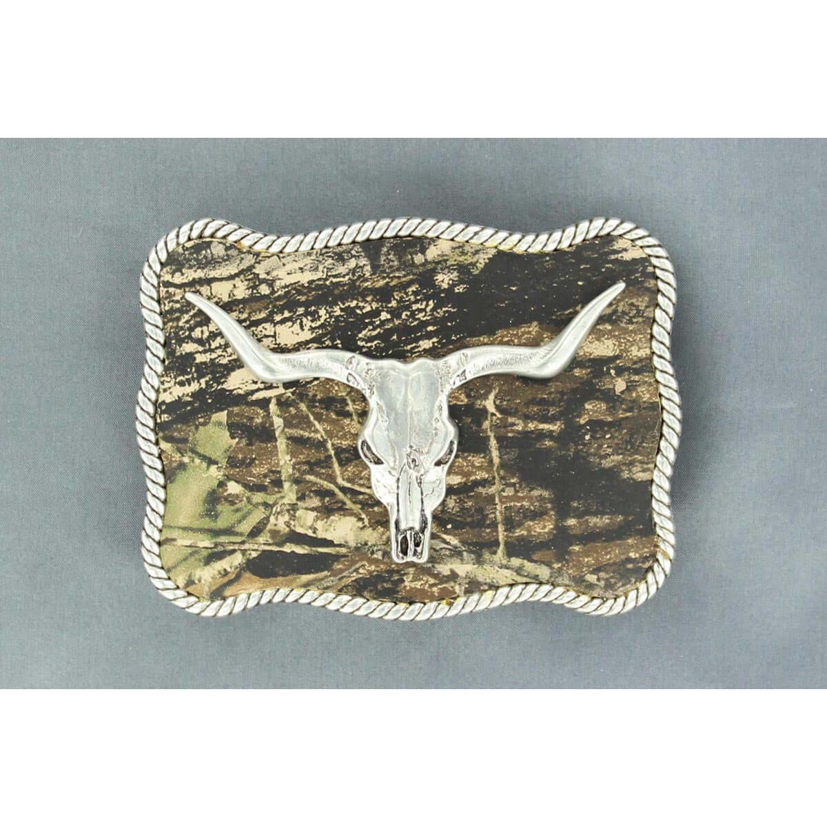 This Nocona buckle is great for any cowboy or hunter.  Belt buckle with silver tone steer skull ornament in the center.  Silver rope border with black inlay highlights.  This buckle offers the latest in cowboy fashion.  Measures approx 2-3/4" x 3-3/4".