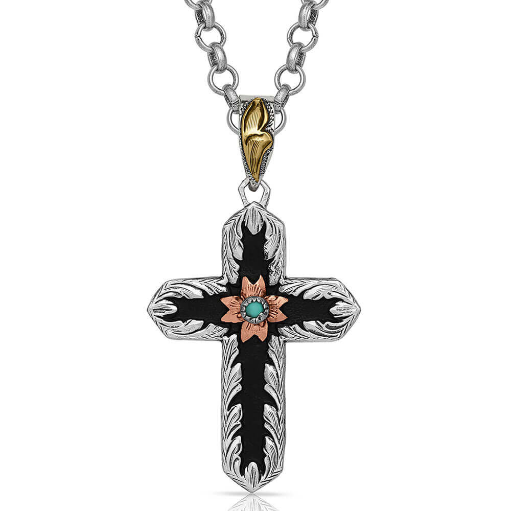 Two-Toned cross German silver necklace has a black overlay that contains a copper-toned small flower in the center holding a small turquoise stone. It dangles from a 28" chain. Pendant measures 1.25 x 2.35. 