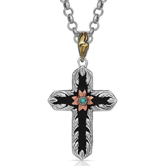 Two-Toned cross German silver necklace has a black overlay that contains a copper-toned small flower in the center holding a small turquoise stone. It dangles from a 28" chain. Pendant measures 1.25 x 2.35. 