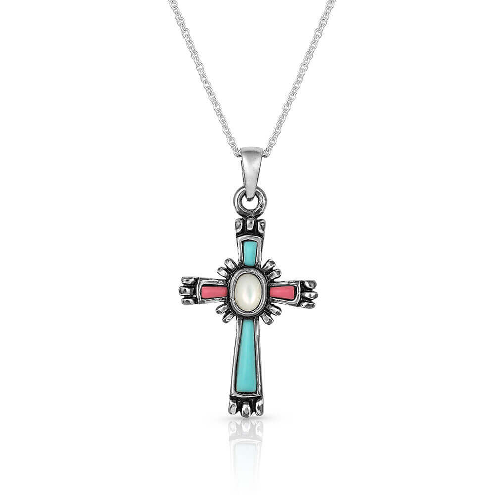 <span>Cross necklace that hangs from a silver-finished clasp and has turquoise with coral-pink gems within the cross. Small figures exude from the corners of the cross with a white mother of pearl stone in the center. It hangs from a 19" silver-toned chain. </span><span>Rhodium over a brass base. Paint. Compressed colored turquoise stones. Mother of Pearl. Pendant measures 1.5" x .75"