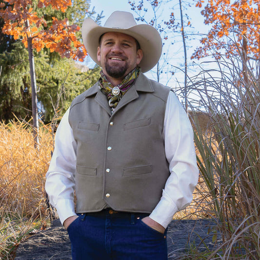 This vest was inspired for Ranch life. Stay warm in this western wool vest made for those outdoor chores or cold morning trail rides. The Range vest has four convenient welt pockets and features dual concealed inner pockets to accommodate both left and right handed individuals. Melton Wool exterior with snap closure and Satin Poly lining. Made in USA.