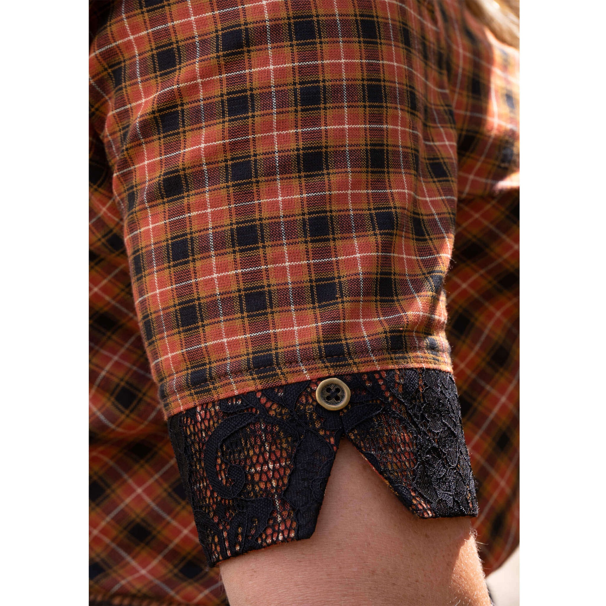 Close-up of Rodeo Round-Up Ladies Shirt showing plaid fabric and lace cuff detail with antique-brass button.