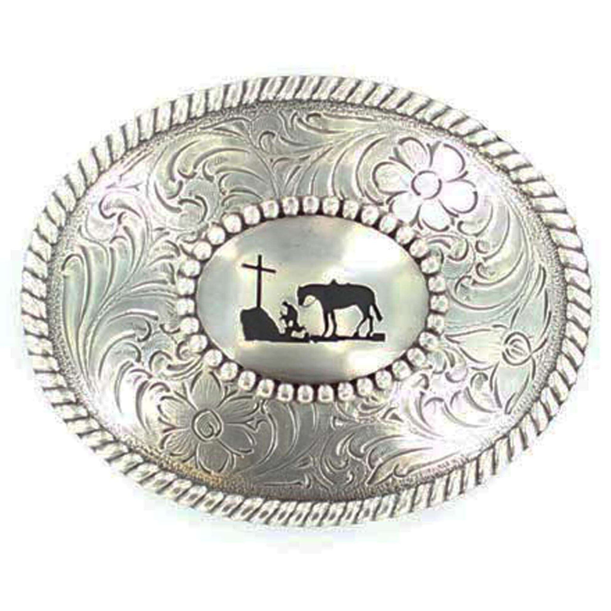 Silver Nocona buckle with rope edge. Cowboy kneeling at Cross with his trusted horse behind him. A scroll and floral design perfectly complements this reverent design. Oval measures approx 3" x 3-3/4".  