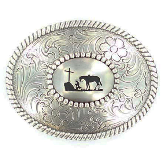 Silver Nocona buckle with rope edge. Cowboy kneeling at Cross with his trusted horse behind him. A scroll and floral design perfectly complements this reverent design. Oval measures approx 3" x 3-3/4".  