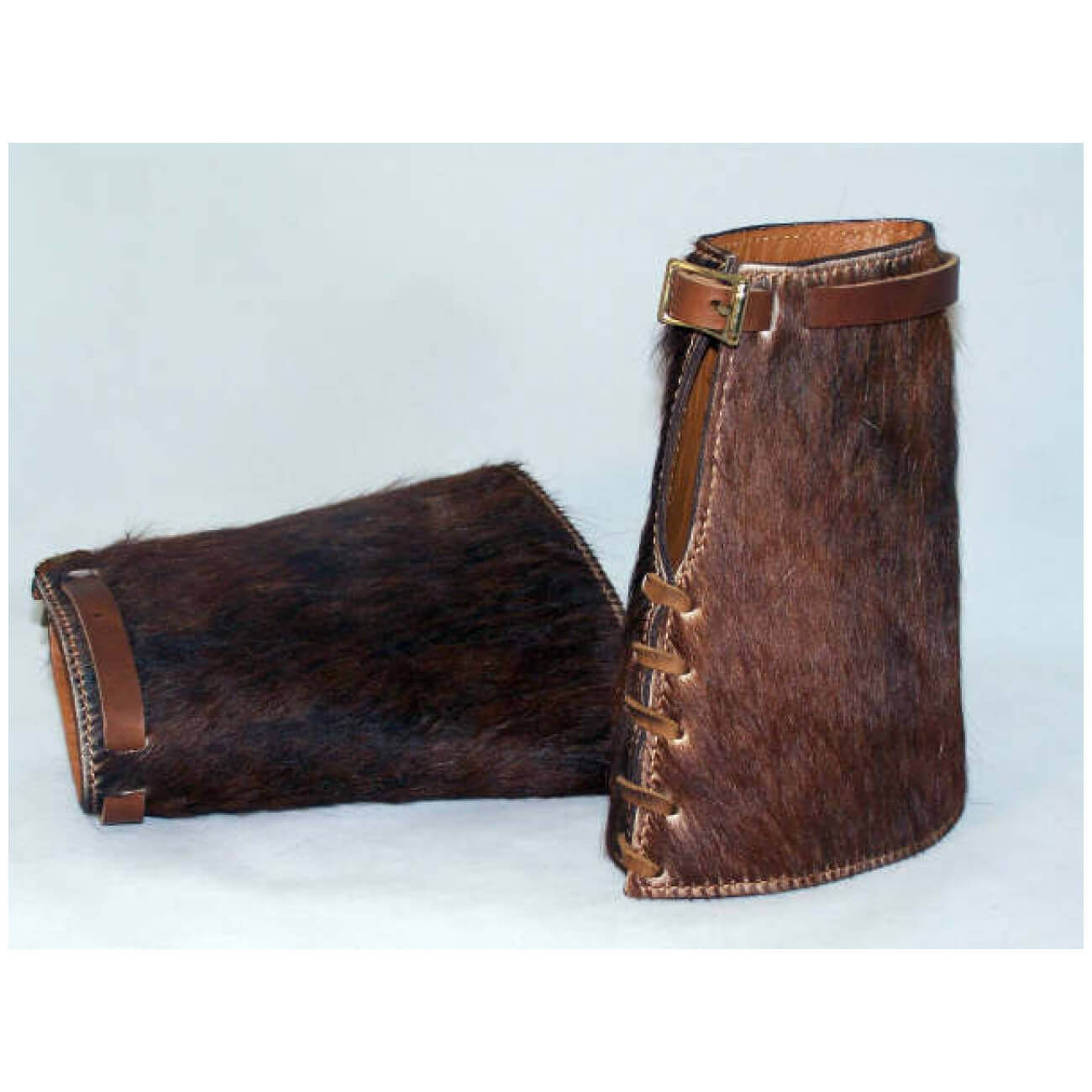 Roping cuffs, or often referred to as riding cuffs, were used by cowboys to protect their wrists from rope burns. Still used today, we offer 7" long, roping cuffs with an adjustable buckle and tie for an easy fit. Comfortable and durable they just get better with age. Color of hair may vary slightly.