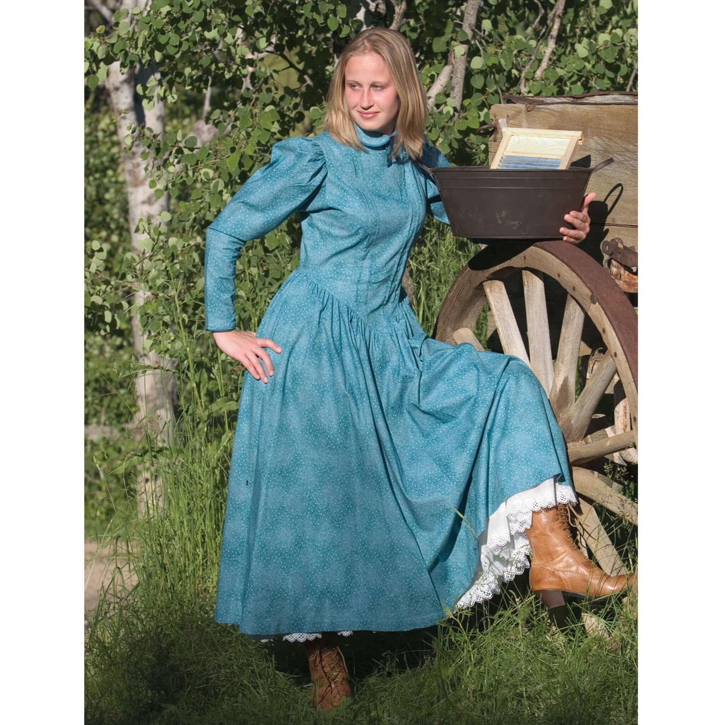Model in a vintage school marm dress with puffed sleeves and boots, set against a rustic backdrop.