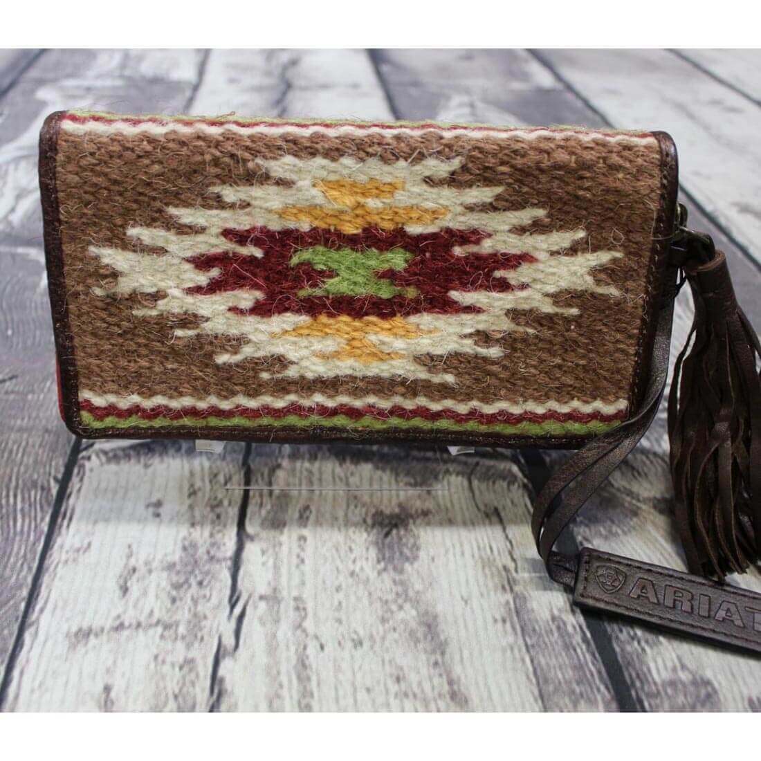 <span>Sheridan clutch wallet made of handwoven fabric on with a zipper closure. Southwestern design. </span><span>Measures: 7-1/2” X 4-1/2” X 1-1/4”. Imported</span>