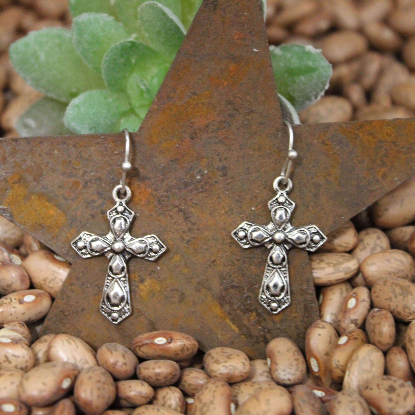 These delicate cross earrings are a beautiful symbol of the faith you carry. The minimalist design features French ear wires with a petite cross pendant. Intricate design etched on 1" by 3/4" crosses.