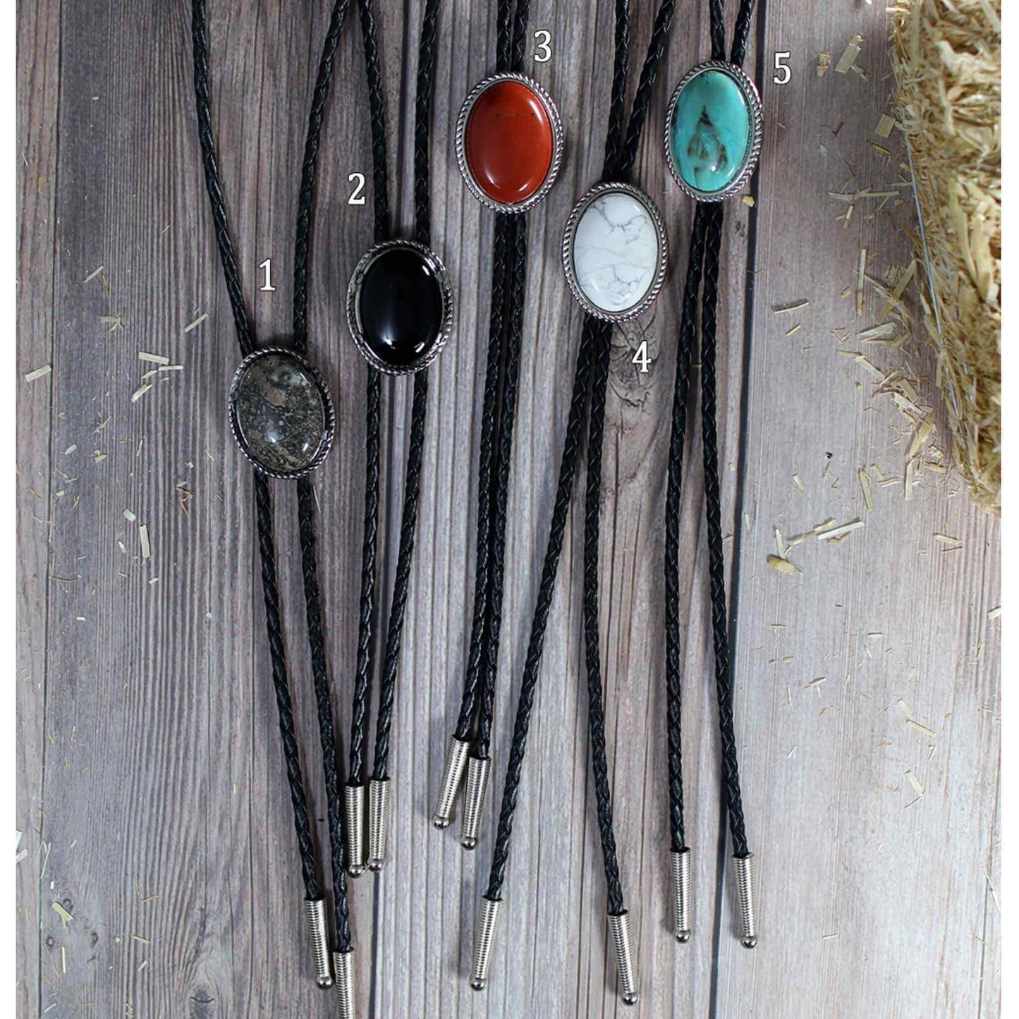 Add color to your western attire neckwear with these bolo ties. Get just the color you need or get a couple to have options. Oval with rope design edge on a black leather cord choose from brown, red, black, white, turquoise or red. Measures 1-1/4" by 1-1/2" on a 30" cord.