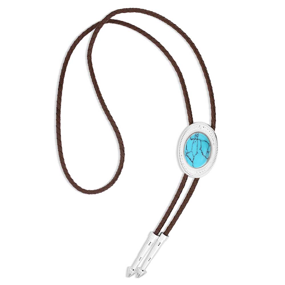 Made for the ones who go against the grain. The Outlaw Turquoise Bolo Tie has a silver tone oval base that has bright cut engravings that frame the center turquoise stone. The brown braided leather cord is weighed with two silver arrow pointed tips to complete the bold design. Stone and color will vary.