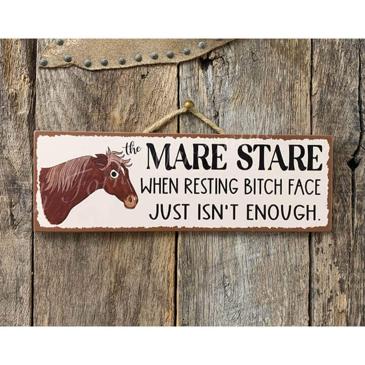 Wooden sign with a horse illustration and humorous text on a wooden background