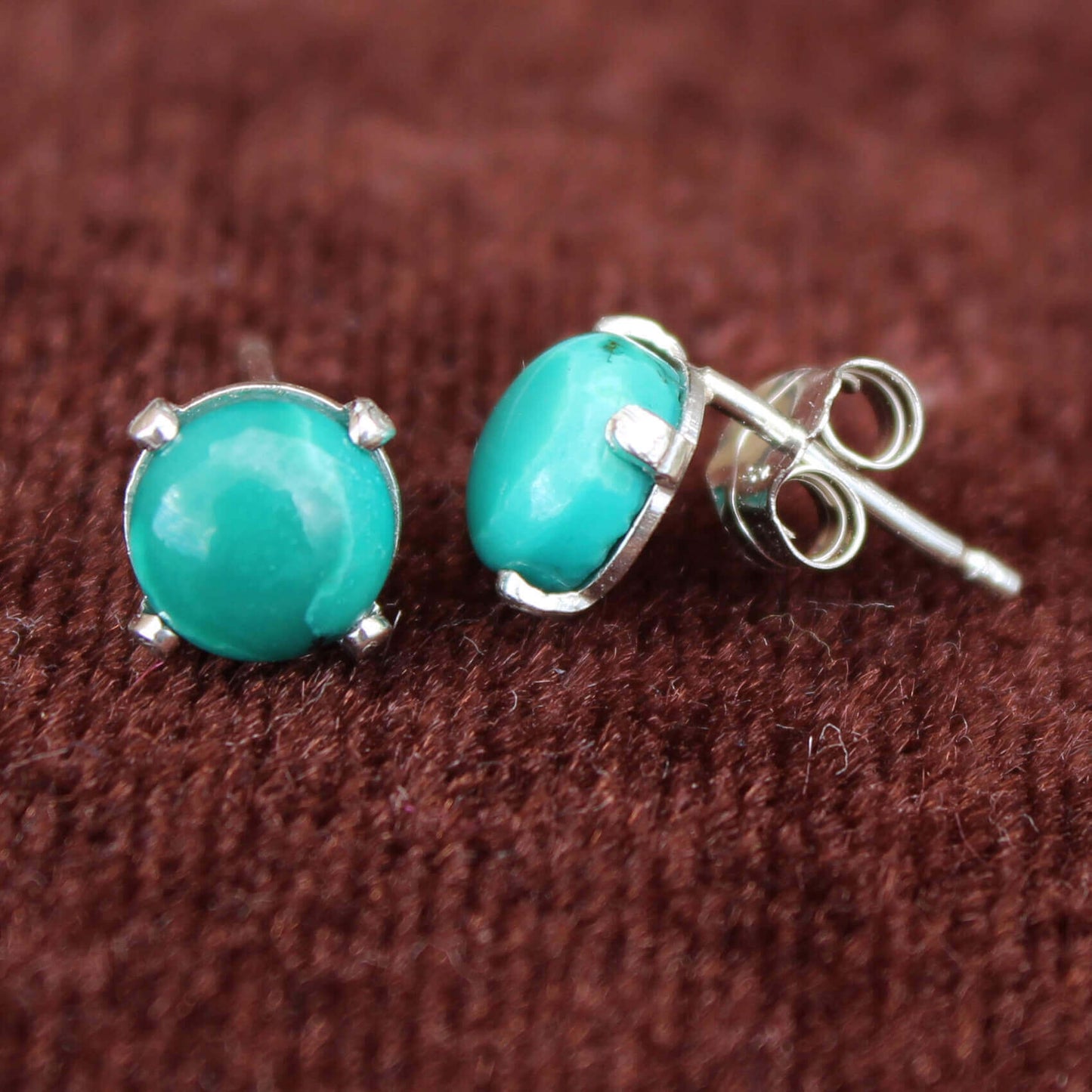 These turquoise earrings are made with high grade turquoise nuggets in shades of deep blues and greens in sterling silver setting. Compliment these with our turquoise nugget necklace. Measures ¼” Diameter. Handmade in USA.