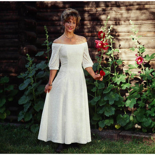 A wispy flow of white cut silk velvet creates daisy flower pattern. This incredibly sensuous design is cut from 18% silk and 82% rayon velvet. Called a wedding dress but the serenade dress is also a fabulous party dress. Completely lined. Zips up in the back. Approximately 35" long from the natural waistline.