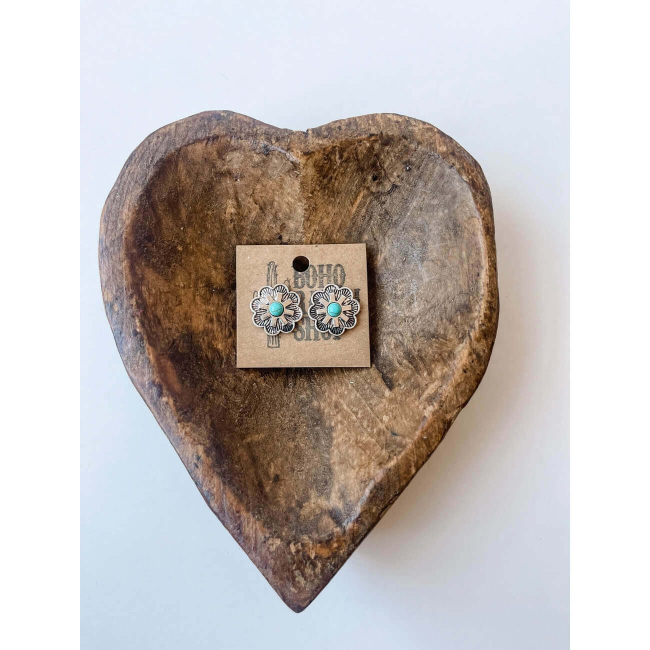 Western Concho Stone Stud Earrings displayed on a heart-shaped wooden dish, featuring turquoise floral designs.